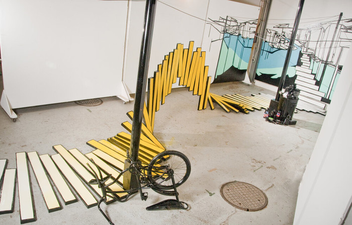 Architecture of Exclusion,  2010. Wood, enamel, cardboard boxes, plastic pole, rubber cord, various recycled materials, bicycle, clothing fabric, plastic bag, and trash bin. Approx.